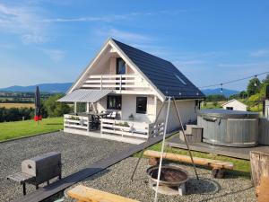 a tiny house with a solar roof on a yard at Slope House (Domek na Skarpie) Lipowa in Lipowa