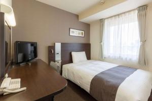 Postel nebo postele na pokoji v ubytování Comfort Hotel Yokohama Kannai