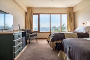 Cama ou camas em um quarto em Wyndham Garden Ushuaia Hotel del Glaciar