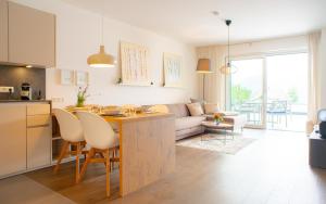 a kitchen and living room with a table and a couch at Top 3 Alpe Maritima - Seetraum in Annenheim