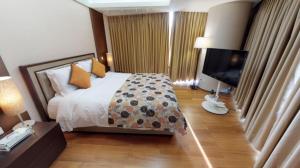 High1 Grand Hotel Convention Tower客房内的一张或多张床位