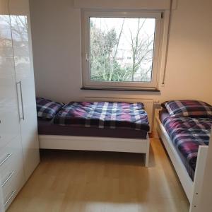 a room with a window and a bench in a room at City Apartment in Eppelheim in Eppelheim