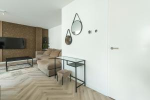a living room with a couch and a table at New Xl Prestige Home With Balconies in Roosendaal
