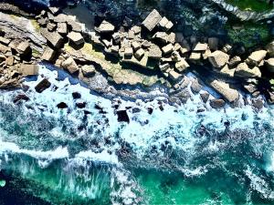 an aerial view of the ocean with rocks and water at Casal Santa Virginia in Sintra