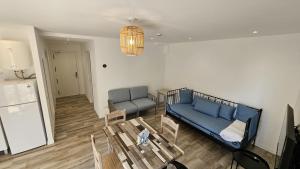 a living room with a couch and a table at Apartamentos Ibiza in Colonia Sant Jordi