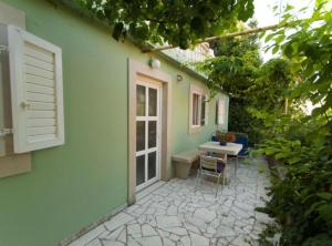 a patio with a table and chairs in front of a house at Apartment Jurišić Korčula in Korčula +31 photos