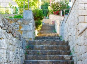 a set of stone stairs next to a stone wall at Apartment Jurišić Korčula in Korčula