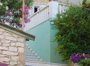 a staircase leading up to a house with flowers at Apartment Jurišić Korčula in Korčula