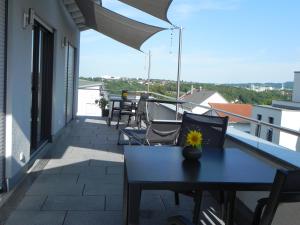 a patio with a table and chairs on a balcony at Apartment Schwäbisch Hall in Schwäbisch Hall