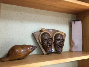 a shelf with a statue of two masks on it at Joya in Ishigaki Island