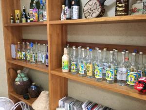 a shelf filled with lots of glass bottles at Joya in Ishigaki Island