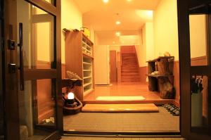 a hallway with a door open to a room at Joya in Ishigaki Island
