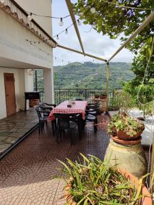 a table and chairs on a patio with a view at La casa di nonna Mary in Diano Castello