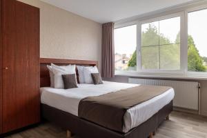 Postel nebo postele na pokoji v ubytování Hotel Olympia in Bruges