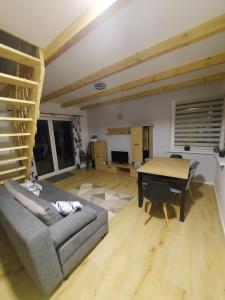 a living room with a couch and a table at Leszczynka in Szarocin +24 photos