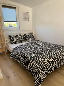 a black and white bed in a room with a window at Studio apartment Adrijana in Zagreb