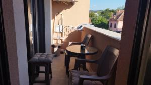 een balkon met een tafel en stoelen op een balkon bij Apartman NEMANJA in Vrnjačka Banja