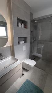 a bathroom with a sink and a toilet and a tub at Zavala Residence in Zavala +18 photos