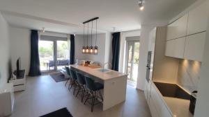 a kitchen with a counter and a island with chairs at Zavala Residence in Zavala