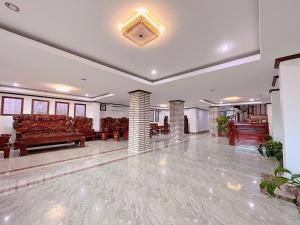 a large lobby with couches and tables in a building at Vangvieng Sisavang Mountain View Hotel in Vang Vieng