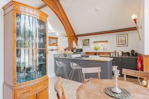 a kitchen with a table and a dining room at The Tracery - Norfolk Cottage Agency in Fakenham