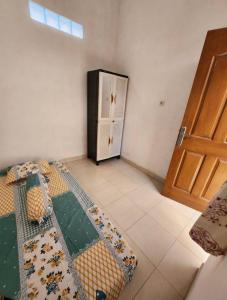 a room with a door and a bed in a room at Lourdes Blessing Hills in Tomohon