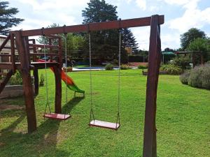 a playground with a swing in a park at La Estrella in Huerta Grande