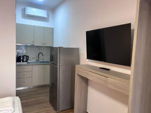 a kitchen with a television on a counter with a refrigerator at Naria Studios in Skala Fourkas