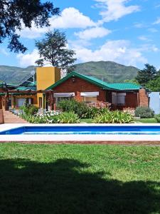 a house with a swimming pool in front of a house at La Estrella in Huerta Grande +29 photos