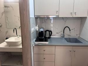 a kitchen with a sink and a counter top at Naria Studios in Skala Fourkas