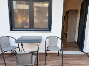a table and chairs sitting next to a window at Naria Studios in Skala Fourkas