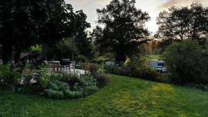 a garden with a table and chairs in the grass at Maison Du Silence in Saint-Maurice-près-Pionsat
