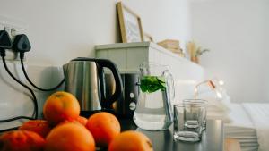 a table with a blender and a bunch of oranges at CURIOCITY Kloof Street in Cape Town