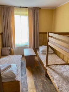 a room with two bunk beds and a window at Dom Wypoczynkowy Relaks in Rytro +46 photos