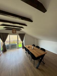 a dining room with a wooden table and chairs at House on the hill in Mostar