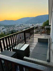 a balcony with benches and a view of a city at House on the hill in Mostar