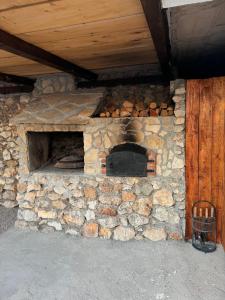 a stone brick oven with a wooden ceiling at House on the hill in Mostar