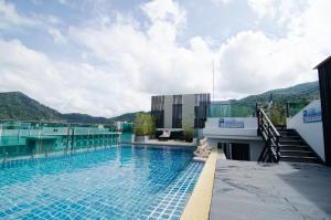 a swimming pool on the roof of a building at Mirage Express Patong Phuket Hotel in Patong Beach