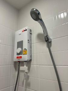 a shower in a bathroom with a shower head at Modern Condo Near Icon Siam & BTS Krung Thonburi in Bangkok