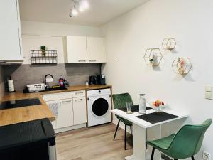 a kitchen with white cabinets and a table and chairs at Ferienappartment in zentraler Lage Passau in Passau
