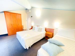 Postel nebo postele na pokoji v ubytování Hotel Bolognese