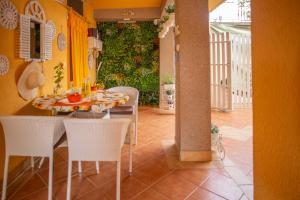 a dining room with a table and white chairs at Villa Rosa in Jelsa