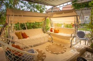 a porch with a swinging bed and a hammock at Villa Rosa in Jelsa