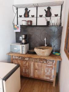 a kitchen with a counter with a bowl on top of it at Casa Pouso Tiradentes 2 in Tiradentes