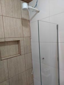 a shower with a glass door in a bathroom at Casa Pouso Tiradentes 2 in Tiradentes +4 photos