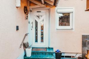 a front door of a house with a potted plant at GADD Ferienwohnung 002 Glück an der Donau I Best Elegant Suite 24 h Check-In in Straubing