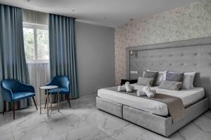 a bedroom with a large bed and a blue chair at Ta Benna in Għajnsielem +34 photos