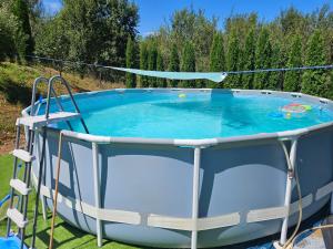 a large circular pool in a yard at Pensiunea Energy in Căpuşu Mic +24 photos