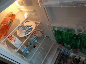 an open refrigerator filled with lots of food and drinks at Maison Chic in Ercolano