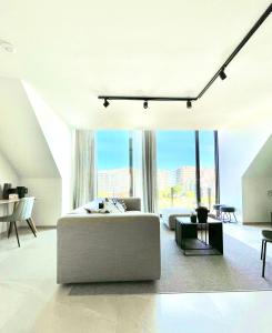 Posezení v ubytování MOLO roof - stylish penthouse with marina view Blankenberge within walking distance from the sea - 15 km from Bruges